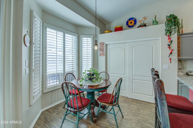 dining room with lofted ceiling and hardwood / wood-style flooring