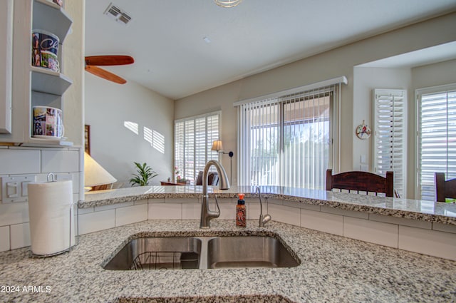 kitchen with light stone counters and sink