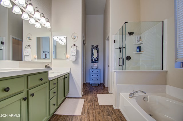 bathroom featuring vanity, hardwood / wood-style floors, and shower with separate bathtub