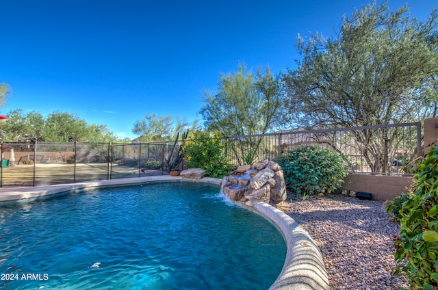 view of swimming pool with pool water feature