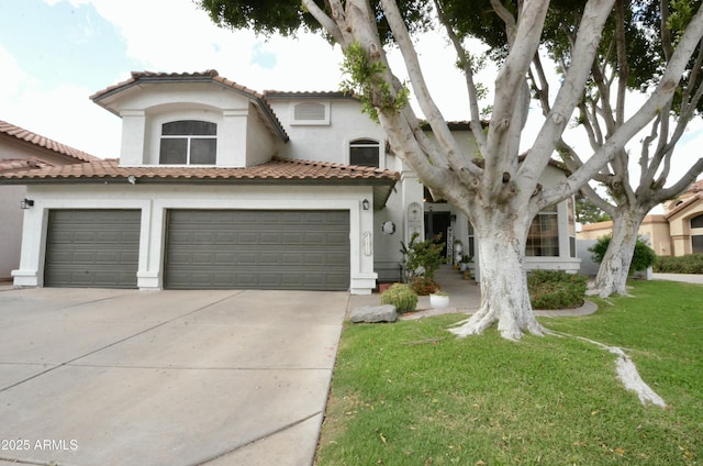 mediterranean / spanish house with a front lawn, a tile roof, stucco siding, driveway, and an attached garage