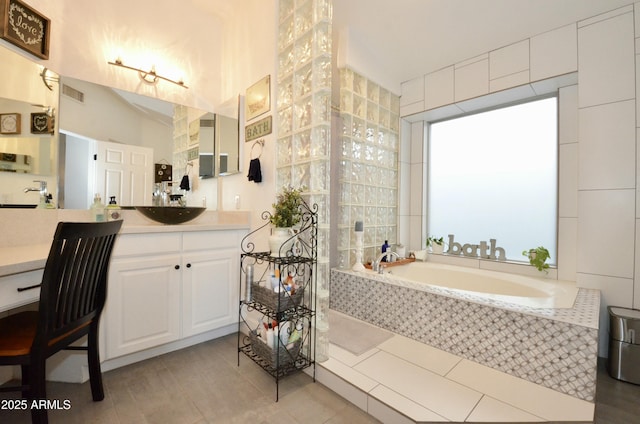 full bathroom featuring a bath, visible vents, and vanity