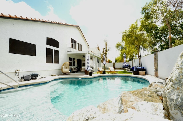 view of swimming pool with a fenced in pool, a fenced backyard, a ceiling fan, and a patio area