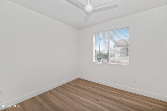 unfurnished room featuring a ceiling fan, baseboards, and wood finished floors