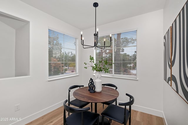 dining room featuring a wealth of natural light, a chandelier, and light hardwood / wood-style flooring