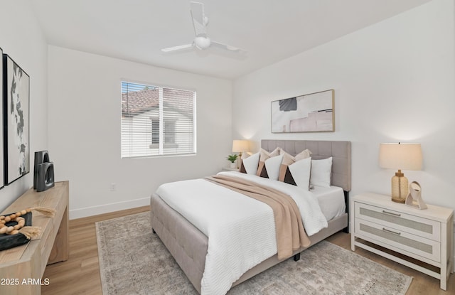 bedroom featuring light wood-type flooring, ceiling fan, and baseboards