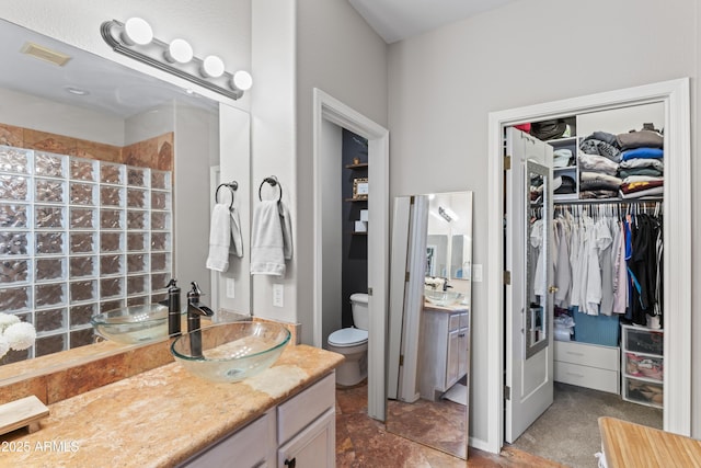 16404 S 18th Dr, Phoenix, AZ 85045 - bathroom featuring vanity, walk in shower, toilet, and a walk in closet