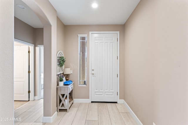 16404 S 18th Dr, Phoenix, AZ 85045 - foyer entrance featuring arched walkways, light wood finished floors, baseboards, and recessed lighting