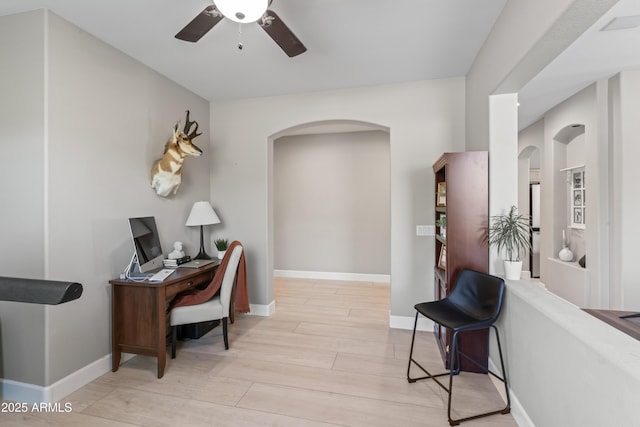 16404 S 18th Dr, Phoenix, AZ 85045 - office area featuring arched walkways, light wood finished floors, ceiling fan, and baseboards
