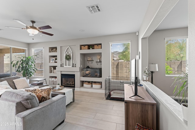 16404 S 18th Dr, Phoenix, AZ 85045 - living room featuring ceiling fan and a glass covered fireplace
