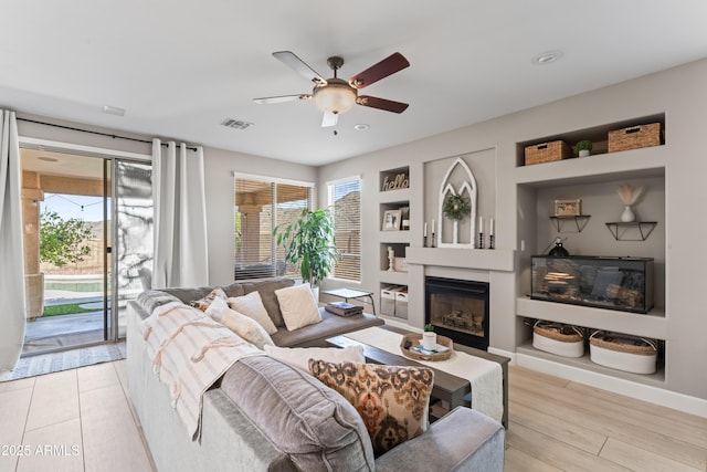16404 S 18th Dr, Phoenix, AZ 85045 - living room with a ceiling fan, plenty of natural light, a glass covered fireplace, baseboards, and recessed lighting