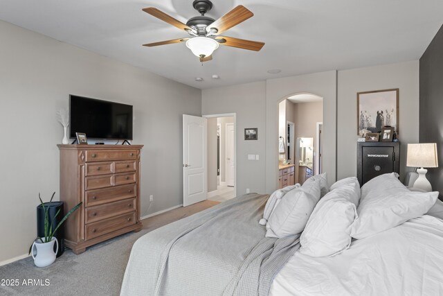 16404 S 18th Dr, Phoenix, AZ 85045 - bedroom with arched walkways, light carpet, baseboards, ensuite bathroom, and ceiling fan