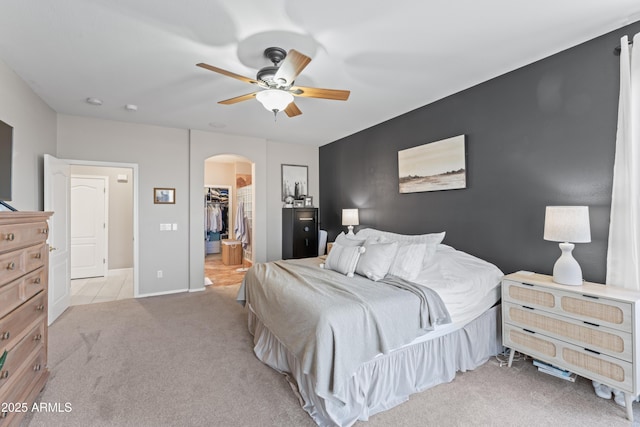 16404 S 18th Dr, Phoenix, AZ 85045 - bedroom with arched walkways, carpet flooring, a walk in closet, a closet, and ceiling fan