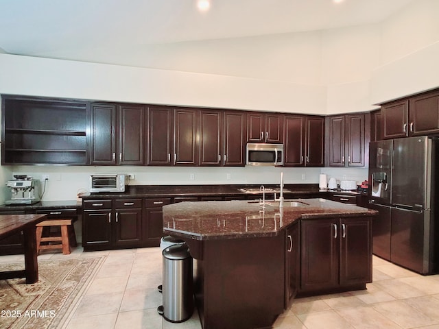 kitchen with open shelves, light tile patterned flooring, a high ceiling, dark stone countertops, and stainless steel appliances
