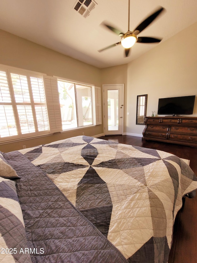bedroom featuring a ceiling fan, baseboards, visible vents, and wood finished floors