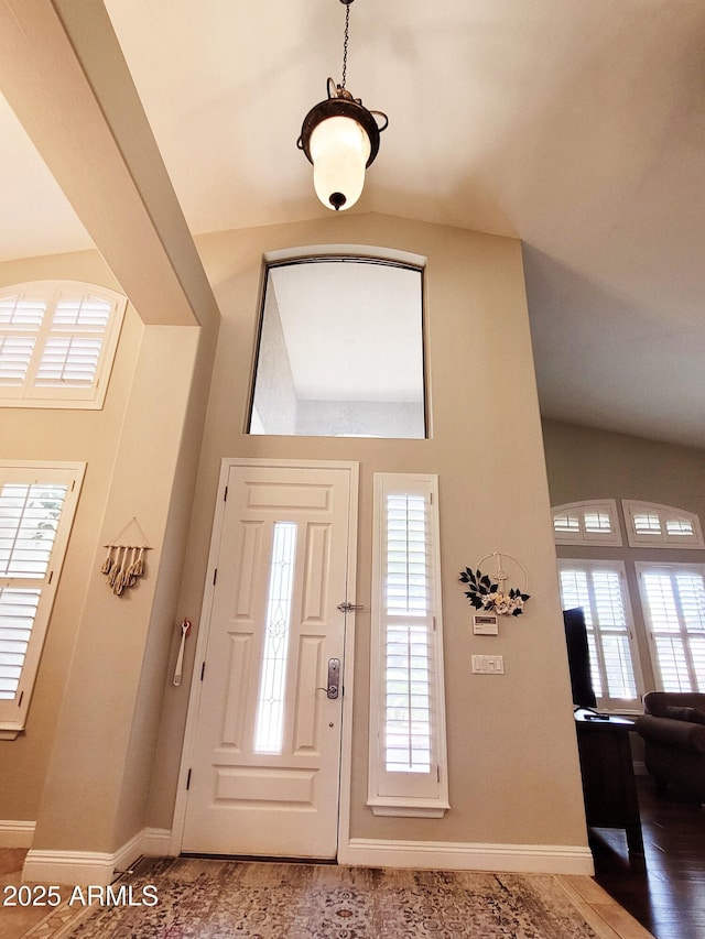 foyer entrance featuring baseboards and a healthy amount of sunlight