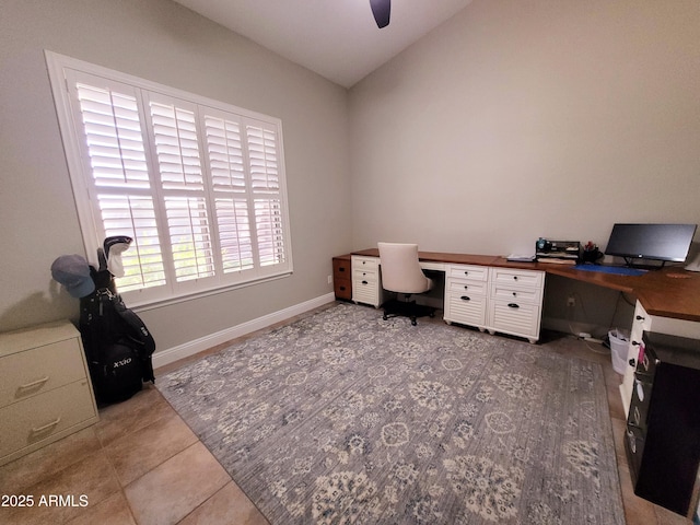 office area with baseboards, ceiling fan, vaulted ceiling, and tile patterned floors