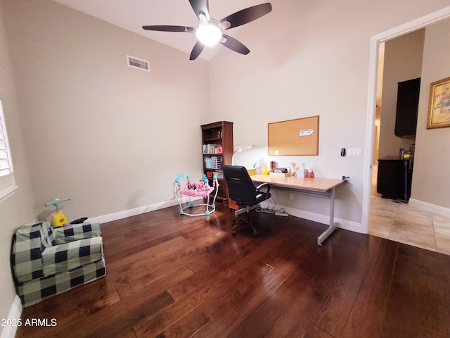 office space featuring visible vents, a ceiling fan, wood-type flooring, and baseboards