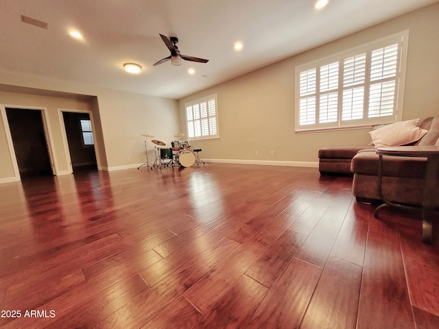 living room featuring a ceiling fan, baseboards, recessed lighting, and wood finished floors