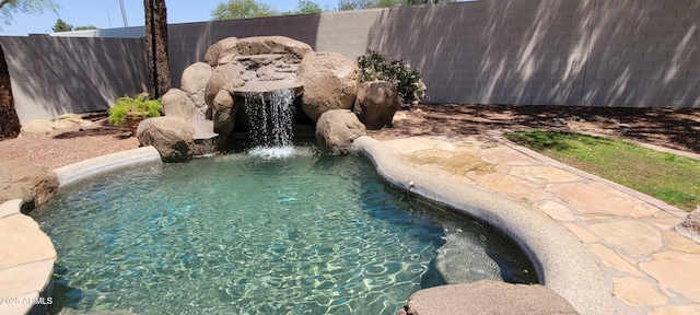 view of swimming pool featuring a fenced in pool and fence