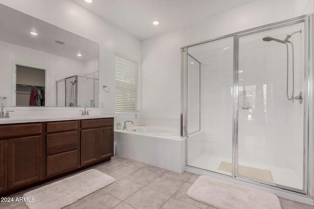 bathroom featuring tile patterned flooring, vanity, and shower with separate bathtub