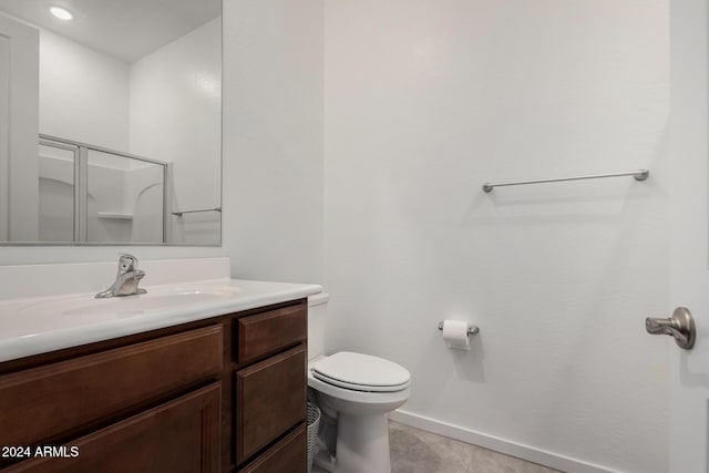 bathroom featuring tile patterned floors, a shower, vanity, and toilet