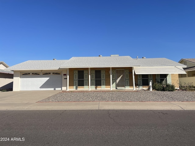 view of front facade featuring a porch and a garage