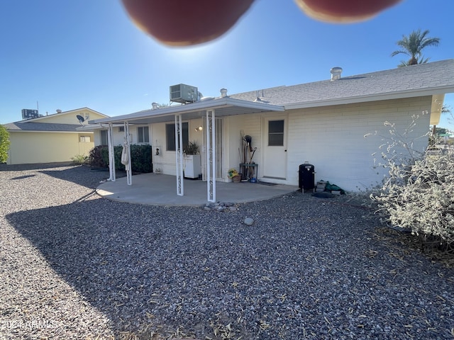 rear view of property with central AC and a patio area