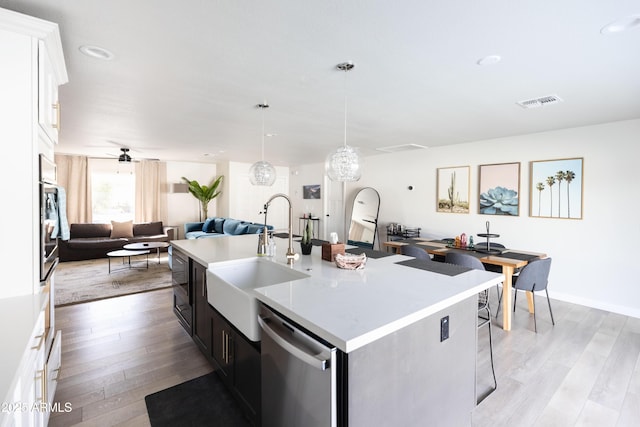 8132 E Valley View Rd, Scottsdale, AZ 85250 - kitchen with a sink, open floor plan, light wood-type flooring, dishwasher, and ceiling fan