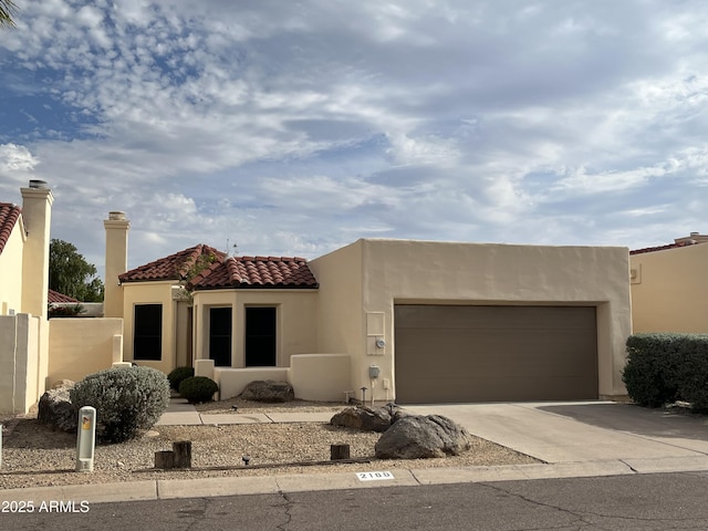 2169 E Bishop Dr, Tempe, AZ 85282 - view of front of home with stucco siding, concrete driveway, an attached garage, and a tiled roof