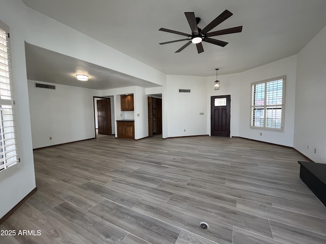 2169 E Bishop Dr, Tempe, AZ 85282 - unfurnished living room featuring ceiling fan, baseboards, and wood finished floors