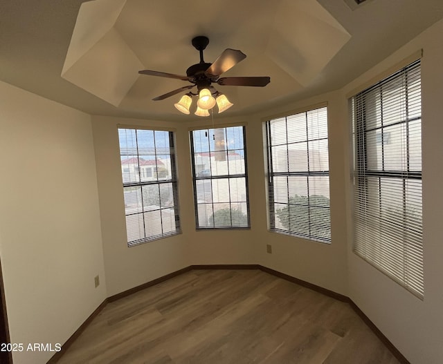 2169 E Bishop Dr, Tempe, AZ 85282 - spare room with light wood finished floors, a ceiling fan, baseboards, and a tray ceiling