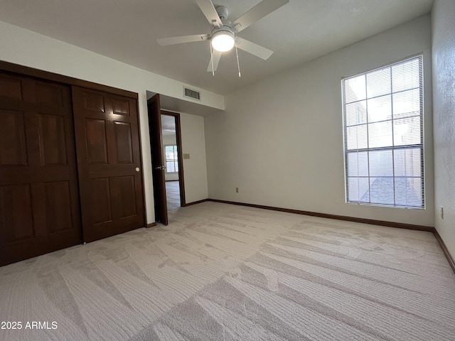 2169 E Bishop Dr, Tempe, AZ 85282 - unfurnished bedroom featuring light colored carpet, baseboards, a ceiling fan, and a closet