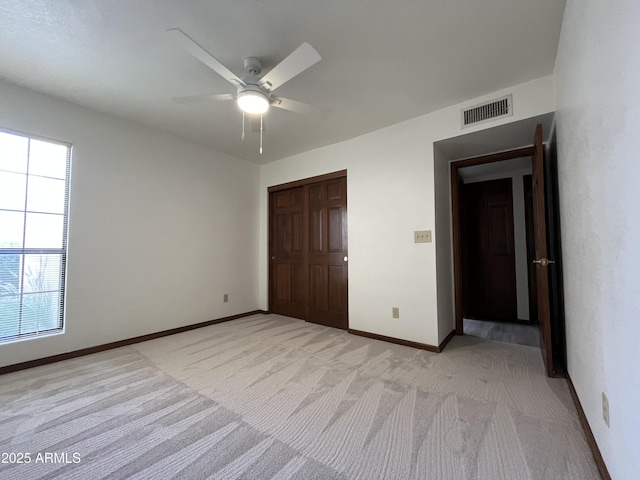 2169 E Bishop Dr, Tempe, AZ 85282 - unfurnished bedroom with a closet, light carpet, baseboards, and a ceiling fan