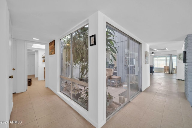 hall featuring light tile patterned floors