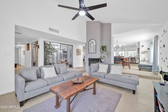 tiled living room with ceiling fan, high vaulted ceiling, and plenty of natural light