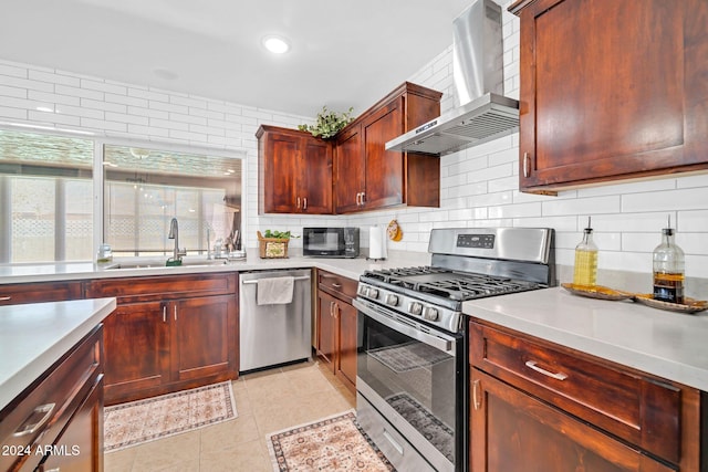 kitchen featuring decorative backsplash, wall chimney range hood, stainless steel appliances, sink, and light tile patterned floors