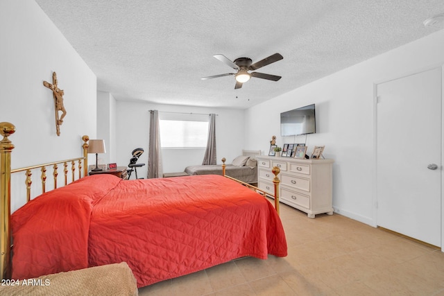 bedroom with a textured ceiling and ceiling fan