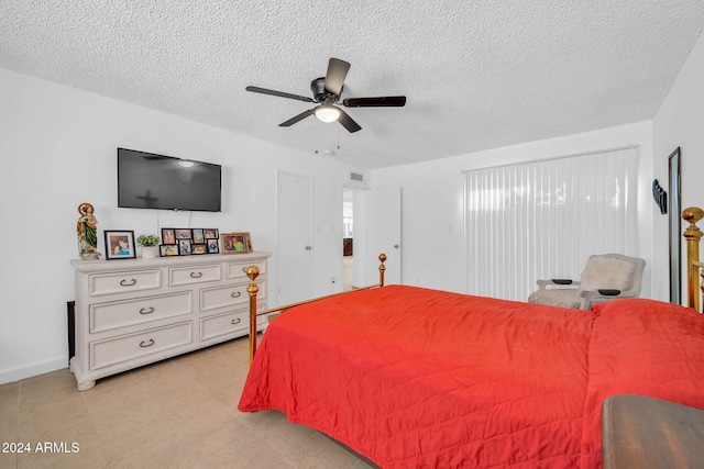 bedroom featuring a textured ceiling and ceiling fan