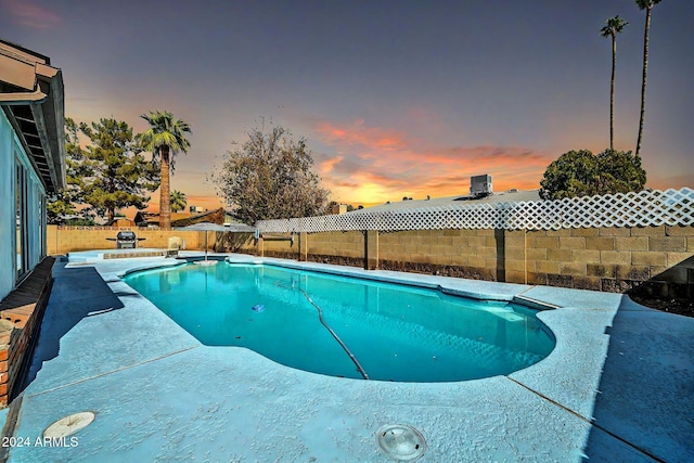 view of pool at dusk