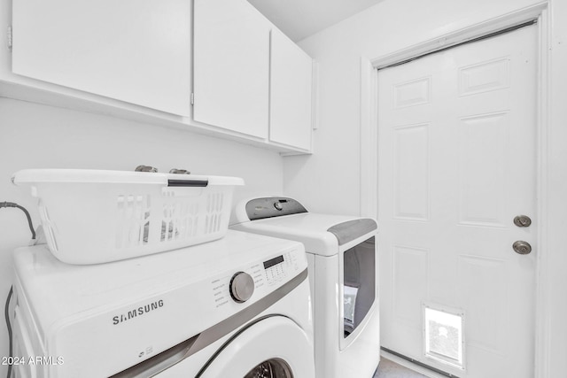 washroom featuring cabinets and separate washer and dryer