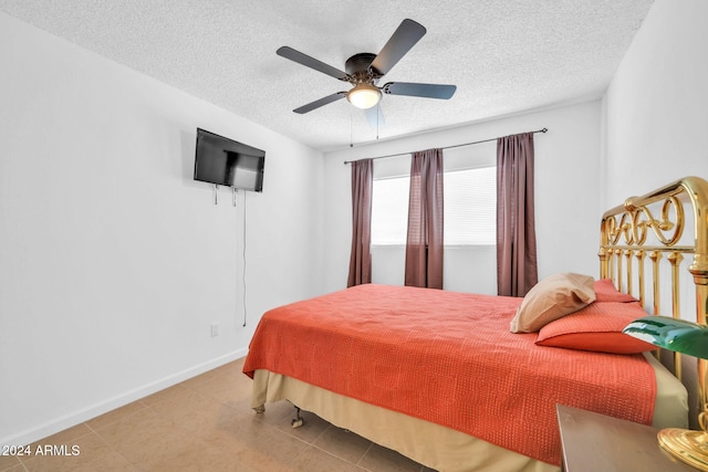 bedroom with a textured ceiling and ceiling fan