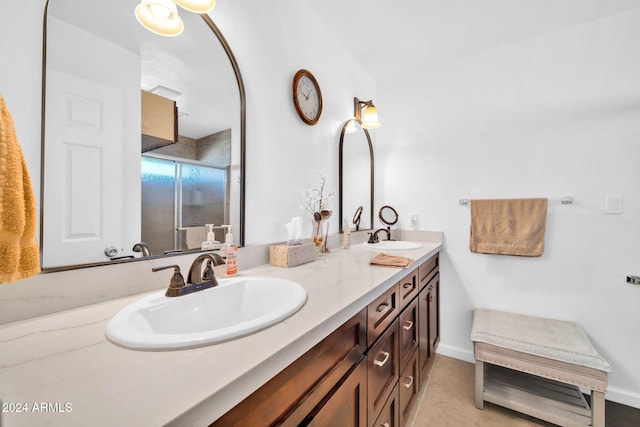 bathroom with vanity, a shower with shower door, and tile patterned floors