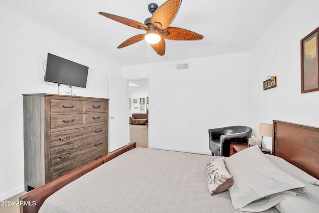 bedroom featuring a textured ceiling and ceiling fan