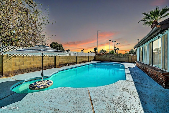 view of pool at dusk