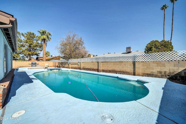 view of swimming pool with a patio