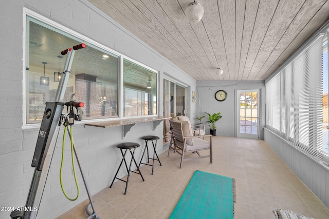 sunroom / solarium featuring wood ceiling