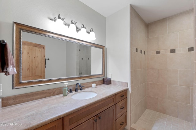 bathroom featuring vanity and a tile shower