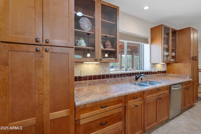 kitchen featuring sink, backsplash, and light stone counters