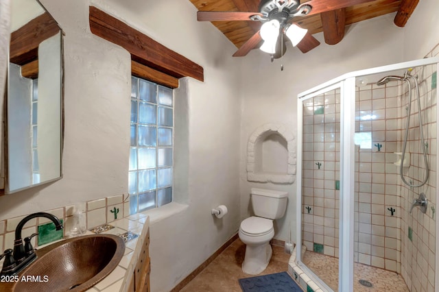 bathroom with beamed ceiling, tile patterned flooring, toilet, a shower with door, and wooden ceiling